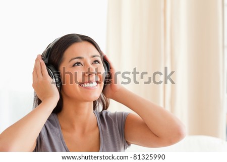 charming woman with earphones in living room