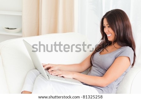 working lady with notebook on sofa in living room