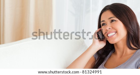 close up of a phoning woman on sofa in living room