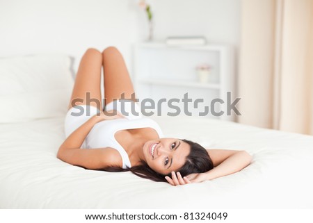cute woman lying on bed in bedroom