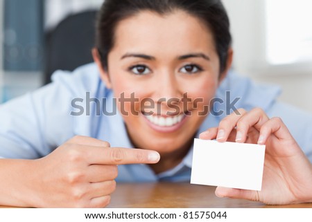 Attractive woman showing her visiting card at the office