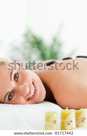 Close up of a blonde woman having a stone therapy in a wellness center