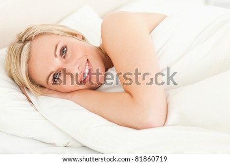 Serene woman opening her eyes in her bedroom