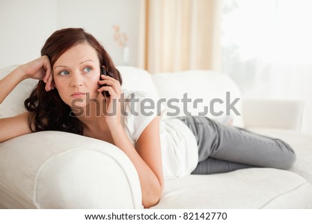 Young woman relaxing on a sofa in the living room