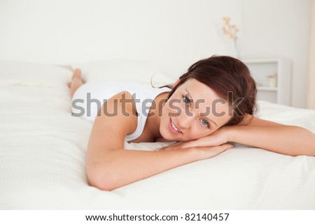 Charming woman relaxing on a bed in her bedroom