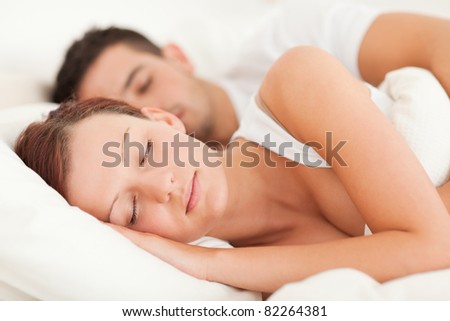 Sleeping couple lying in their bed in the bedroom
