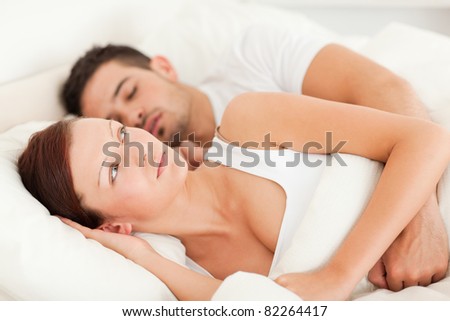 Woman waking for the sound of snores in the bedroom