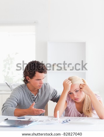 Man trying to comfort his wife in their living room