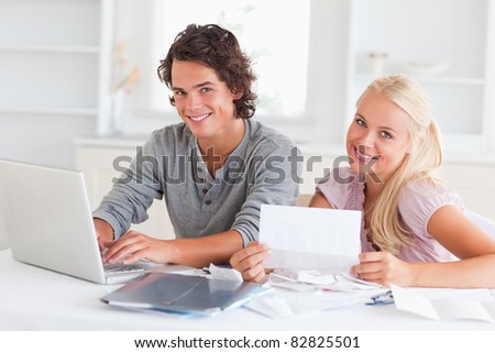 Confident couple accounting in their living room