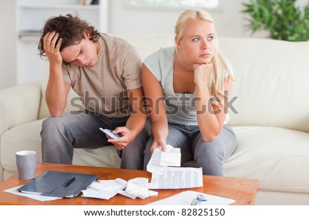 Couple figuring out what to do sitting in the livingroom