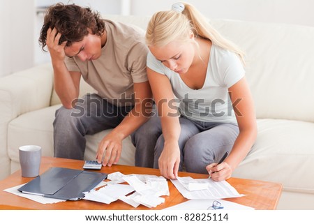Worn out couple working together in the living room