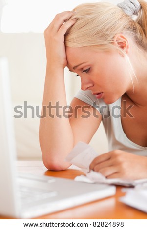 Close up of a Worried blond woman accounting in the living room