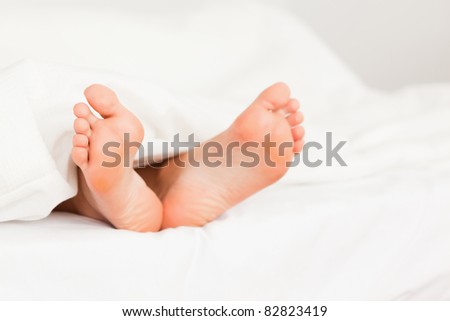 Close up of a woman feet in a bed