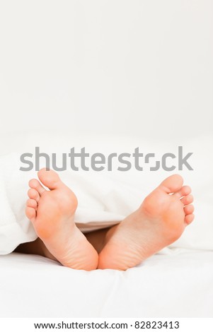 Close up of feet in a bed