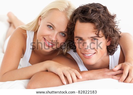 Couple lying on their bed in the bedroom