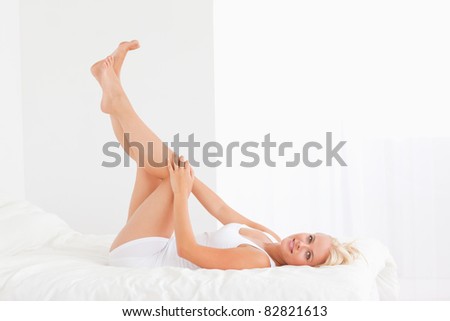 Beautiful woman with the legs up looking at the camera