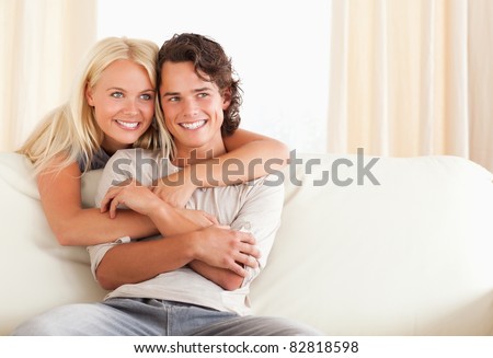 Gorgeous couple hugging in their living room