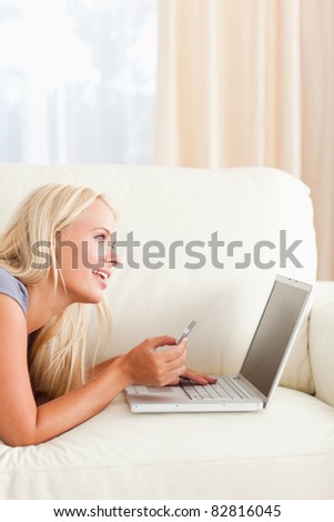 Portrait of a beautiful woman purchasing online in her living room