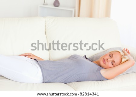 Calm woman lying on a couch in her living room
