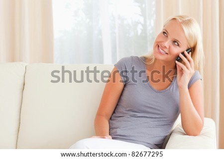 Woman speaking on the phone in her living room