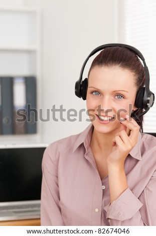 Red-haired woman with headset in an office