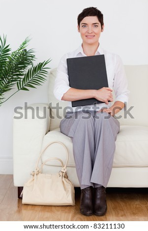 Portrait of a Brunette short-haired woman sitting on a sofa in a waiting room
