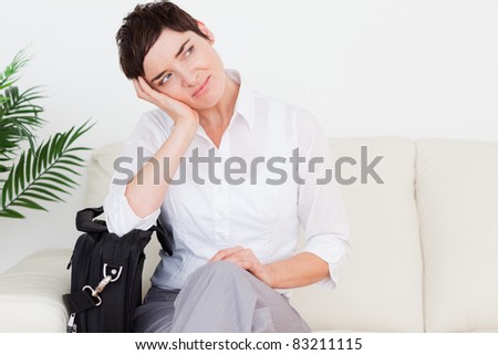 Tired Businesswoman with a bag in a waiting room
