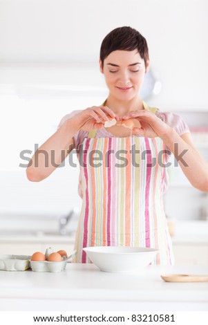 Beautiful woman preparing a cake in a kitchen