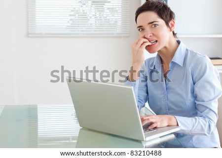 Upset brunette Businesswoman with a laptop in an office