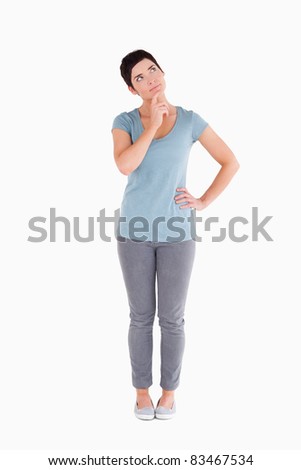 Thoughtful woman standing up against a white background