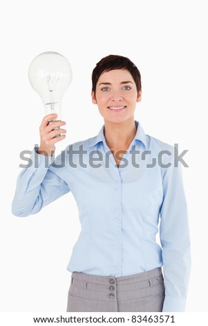 Woman holding a light bulb against a white background