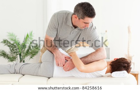 A masseur is massaging a customer