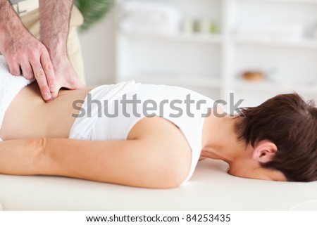 A chiropractor is massaging a woman