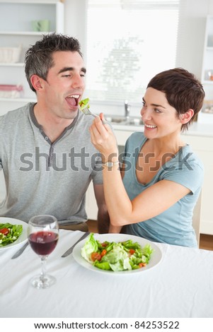 Woman feeding her boyfriend in a dining room