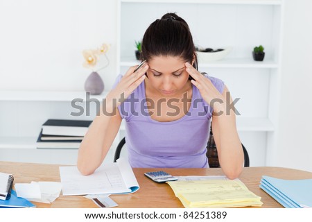 A stressed young woman is accounting