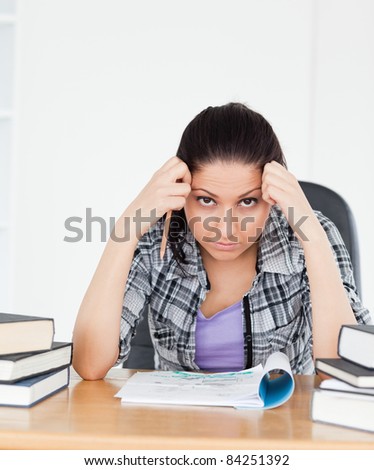 A stressed student is looking into the camera