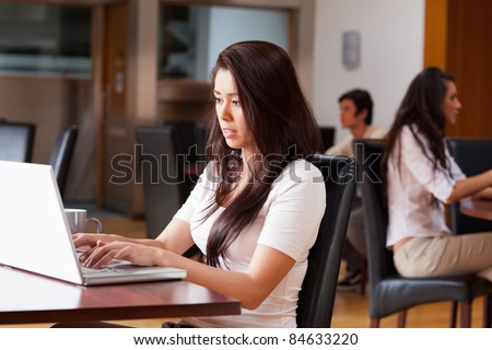 Young woman using a notebook in a cafe