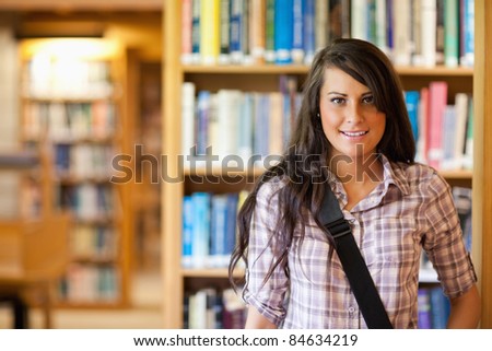 Portrait of a student posing in a library