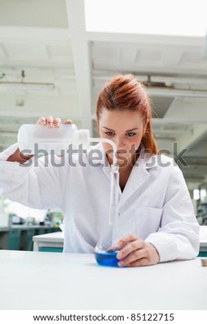 Portrait of a science student doing an experiment in a laboratory