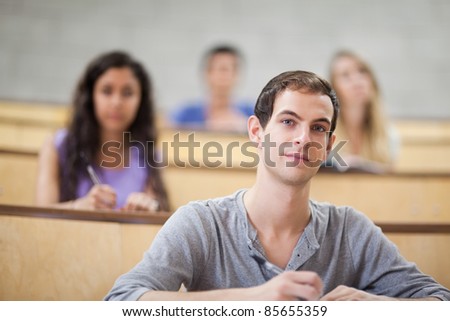 Young students listening during a lecture with the camera focus on the foreground