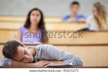 Student sleeping during a lecture in an amphitheater