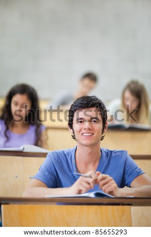 Portrait of focused students during a lecture with the camera focus on the foreground