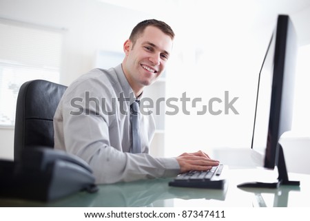 Smiling businessman working with his computer