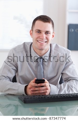 Close up of smiling businessman getting a text message