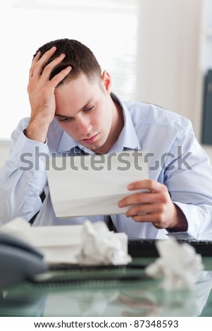 Frustrated businessman reading a bill