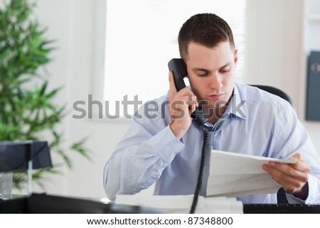 Young businessman calling the author of a letter