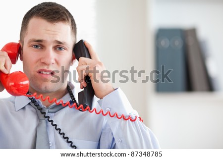 Stressed businessman troubled by the telephone