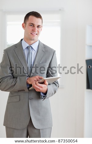 Smiling businessman pointing at his notes