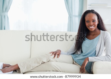 Smiling woman relaxing on couch