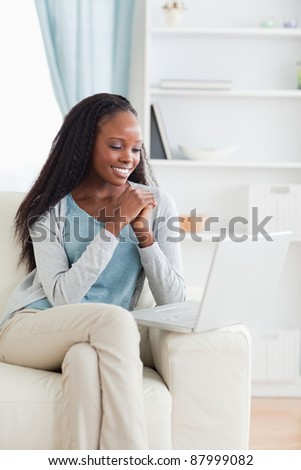 Smiling woman looking at computer screen